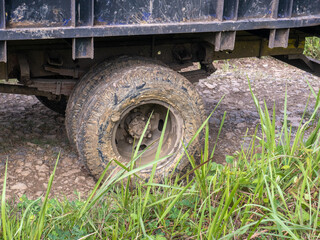 Fototapeta na wymiar truck tires full of dirt and rusty wheels