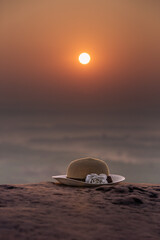 Straw hat in the morning sun at three whale rocks Bueng Kan, Thailand. 