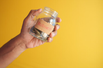  men holding a saving coin jar 