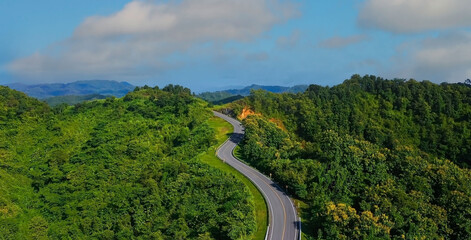 The highway stairs to the sky of road trough with green nature forest  as the natural landscape background