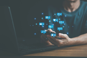 Man hand use smart phone on social media interactions , notification icons, like, message, email, comment  above smartphone screen, internet digital marketing.