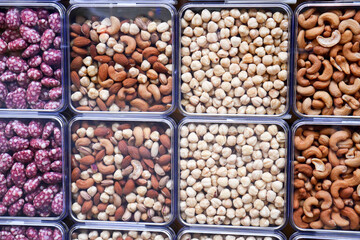 close up of many mixed nuts in a box on table 