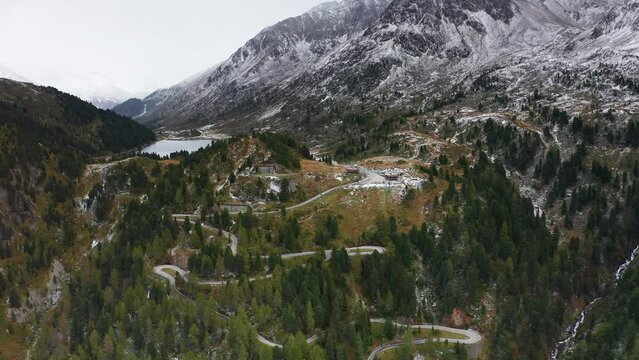 Drone flight over winding forest road,  beautiful and peaceful surroundings for a cinematic experience. Passo stalle, alto Adige, Italy.