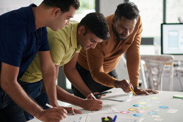 Team of UX designers choosing icons for new mobile application
