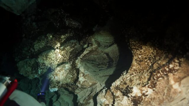 Budapest - 17 August 2017: Technical diver in red flippers in the underwater cave of Budapest