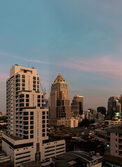 Architectural view of skyscrapers at bangkok city in the evening time. Beautiful of Modern high-rise buildings and Geometric of building design, Conceptual urban building construction.