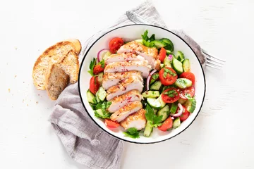 Poster Salad with chicken meat. Fresh vegetable salad with chicken breast. Meat salad with chicken fillet and fresh vegetables on plate. © bit24