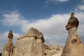 Hot air balloon flying over fairy chimneys and rock landscape at Cappadocia Turkey