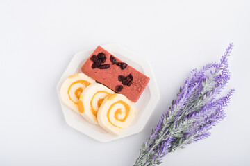 Brownie cake and orange roll cake on withe plate, ready to eat
