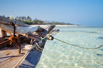 Photo sur Plexiglas Plage de Nungwi, Tanzanie Traditional boat on beautiful beach and tropical sea at low tide in Jambiani, Zanzibar, Tanzania Africa