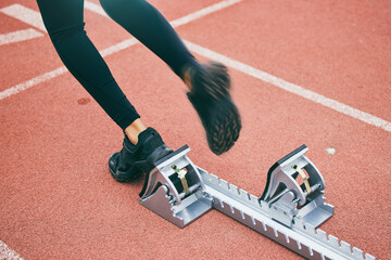 Feet, running and race start blocks with woman athlete on stadium, motion blur and speed, action...