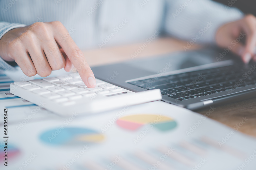 Poster accountant calculating figures in company financial documents with a calculator,analysis of company 