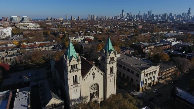 Chicago USA, Aerial View of St Josaphat Catholic Church and Downtown Towers in Background on Sunny Autumn Day, Drone Shot