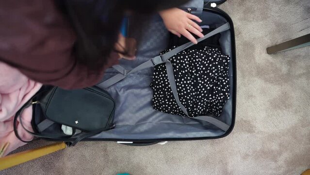 Packing a suitcase, girl packing luggage ready for a trip