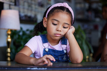 Sad, bored and lonely kid in home, depressed or upset while thinking alone in house. Loneliness,...