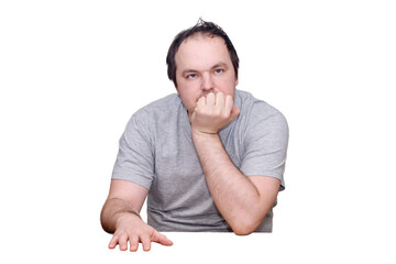 An adult man of 40 years old in casual clothes sits thoughtfully at the kitchen table. Problems in life with despair, grief, and melancholy, isolated on a white background