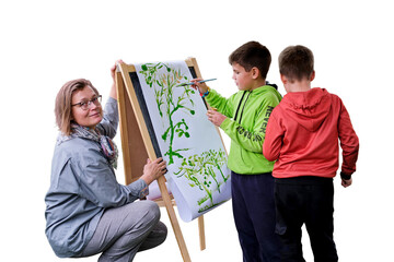 Mother teaches to paint with two boys pupils, isolated on a white background. Woman teacher artist...