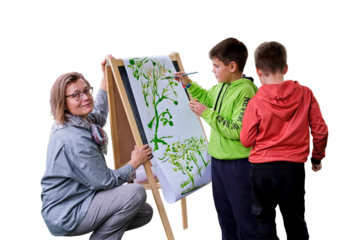 Mother teaches to paint with two boys pupils, isolated on a white background. Woman teacher artist paints with children on paper nature and trees by the river