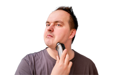 Portrait of disheveled adult man shaving stubble with electric razor, isolated on a white background