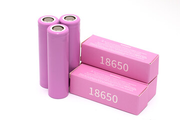 Three lithium batteries isolated on a white background next to packs of batteries, rechargeable...