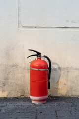 an old fire extinguisher abandoned by the roadside