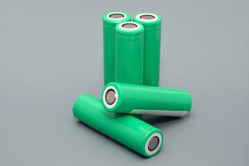 18650 batteries lie on a soft gray background. Batteries for equipment , lithium - ion