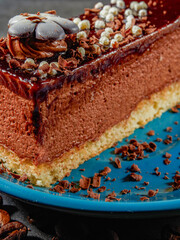 Three chocolates cake with chocolate drips on a black background. Layered cake with milk, black and white chocolate souffle decorated with strawberries on top. Confectionery background with copy space