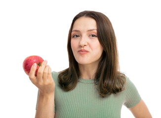 Young caucasian happy vegetarian woman eats with pleasure red apple fruit. Iisolated on white background portrait. Beautiful girl posing in studio. People lifestyle food concept.