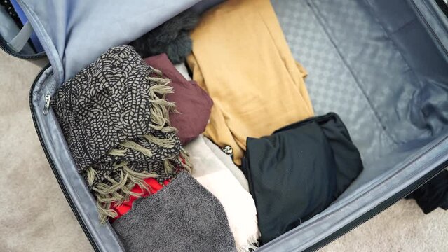 Packing a suitcase, girl packing luggage ready for a trip