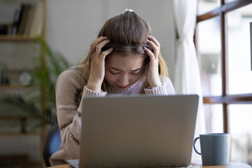 Serious young asian woman working on laptop business successful technology concept
