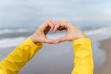 Woman hands showing the heart symbol as love messege. Saying I love you with love symbol. Valentine...