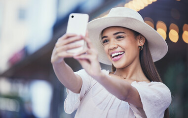 Woman, vlogger and social media with smile in the city for selfie, travel or profile picture and...