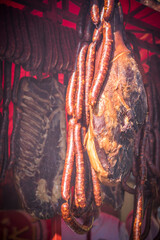 Fototapeta na wymiar Dry meat and sausages hanging at the outdoor market stall