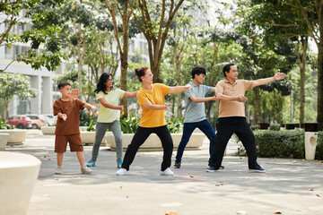 Family Exercising in City Park