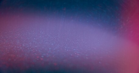 Blur glitter glow. Bokeh light overlay. Glamour shimmering gleam. Defocused neon blue pink color flare sparkles texture abstract copy space background.