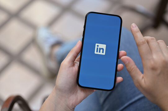 Top View Of A Female Hands Holding A Smartphone With LinkedIn Logo On Screen