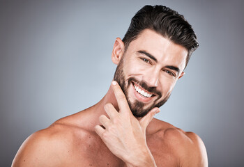 Skincare, teeth and health, portrait of man with smile, hands on face and beard or dental maintenance. Fitness, spa facial care, happy male model with muscle in studio isolated on grey background.