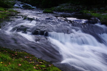 Fototapeta premium Landscape photo of steep waterfall in mountain stream
