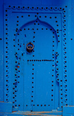 Typical blue ancient arabic style door in Morocco