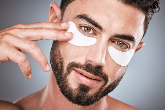Face, Skincare And Man With Eye Patches In Studio Isolated On A Gray Background For Wellness. Portrait, Dermatology And Male Model With Cosmetics, Facial Treatment Or Mask Product For Healthy Skin.