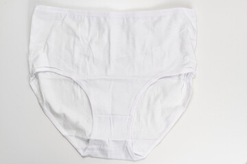 a white cotton panties on a white background. the concept of classic underwear made of natural fabrics.