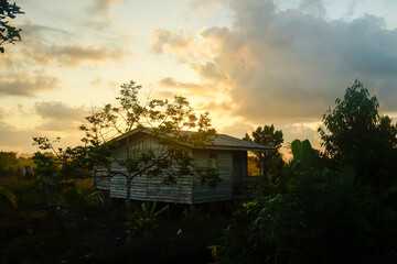 the silhouette of a traditional transmigrant house in northern Kalimantan