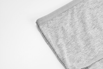 part of a gray cotton panties on a white background. the concept of classic underwear made of natural fabrics.