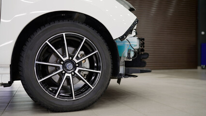 Car repair at the station. The concept of service, repair and maintenance of cars. Electric vehicle wheel.