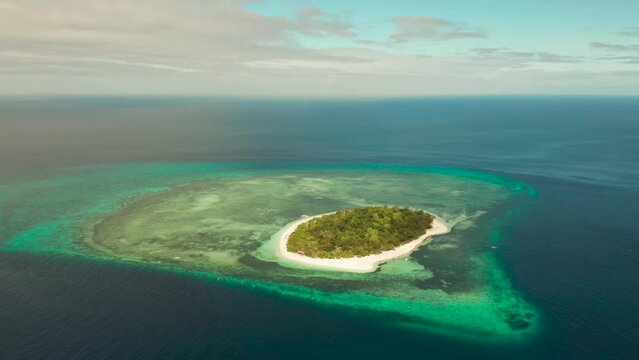 Beautiful beach on tropical island surrounded by coral reef, top view. Mantigue island. Small island with sandy beach. Summer and travel vacation concept, Camiguin, Philippines, Mindanao