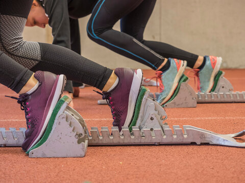 Two women runners on tartan track in starting position, Offenburg, Baden-W&uuml;rttemberg, Germany
