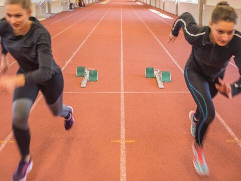 Two women running on tartan track, Offenburg, Baden-W&uuml;rttemberg, Germany