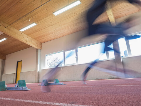Blurred motion of two women running on tartan track, Offenburg, Baden-W&uuml;rttemberg, Germany