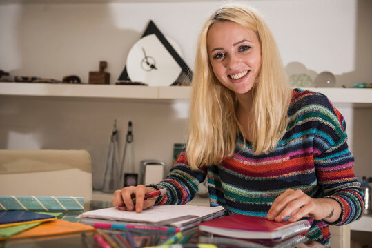 Portrait of a young student doing homework in the living room, Bavaria, Germany