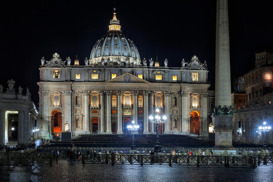 Illuminated cathedral and column at St Peter Square, Rome, Italy